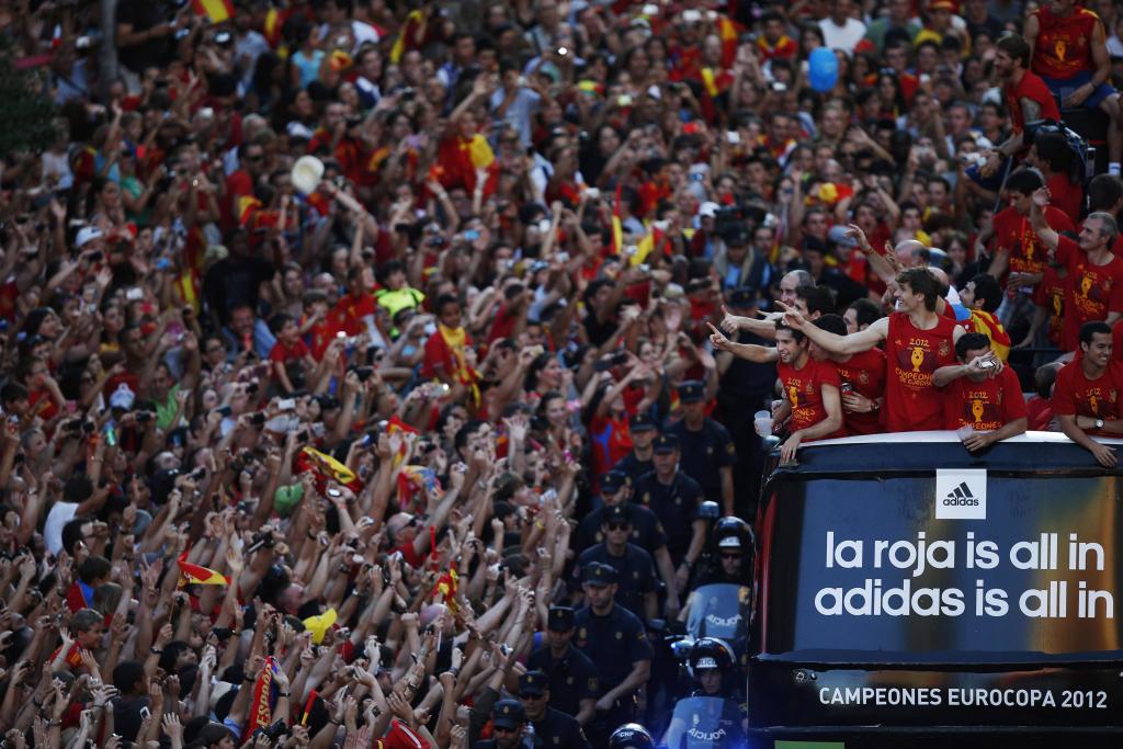Spain's national soccer team players celebrate their Euro 2012 victory on an open top bus during a parade in downtown Madrid