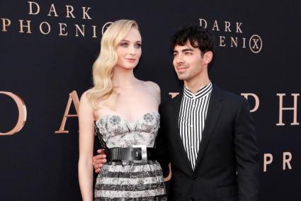 FILE PHOTO: Actor Sophie Turner poses with her husband Joe Jonas at the premiere for the film "Dark Phoenix" in Los Angeles