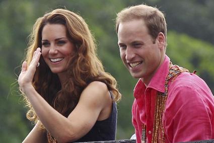 Britain's Prince William and Catherine, the Duchess of Cambridge, smile during their arrival at Marapa Island