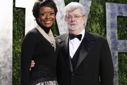 File photo of director George Lucas and his partner Mellody Hobson arriving at the 2012 Vanity Fair Oscar party in West Hollywoo