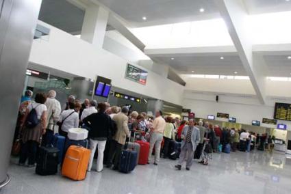 Homeward bound. Vistors queuing to leave the island as airport returns to normal