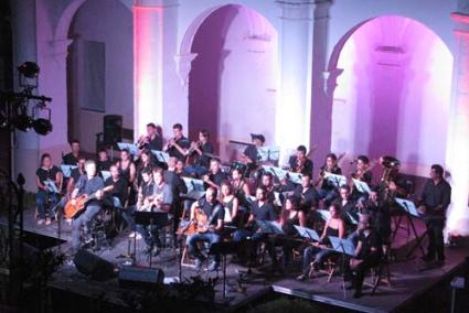 fusió. Cris Juanico, Toni Xuclà i Juanjo Muñoz interpretaren quatre cançons amb la Banda de Música de Ciutadella - llac