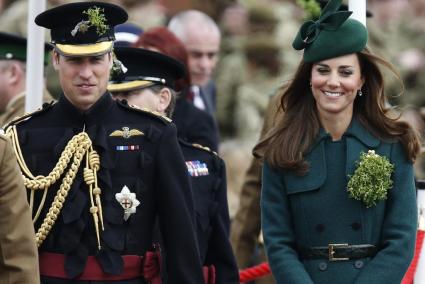 Britain's Catherine, Duchess of Cambridge and her husband Prince William wear sprigs of shamrock during a visit to the 1st Batta