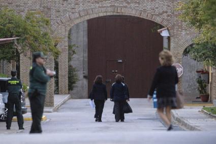 La tonadillera Isabel Pantoja, condenada a dos años de prisión por blanqueo de capitales, se dirige, seguida por dos funcionarias, a la entrada de la cárcel sevillana de Alcalá de Guadaira para cumplir su pena