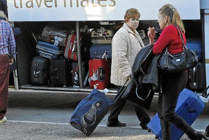 Los turistas sénior recién llegados a la Isla suben al autobús que les llevará hasta el hotel.