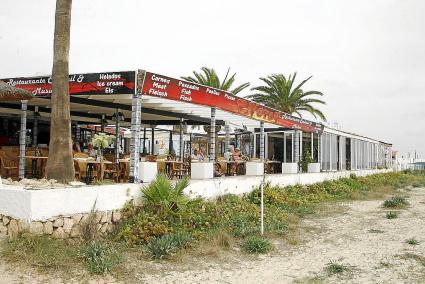 El restaurante Noray en la playa y a continuación, junto a las terrazas, las casetas al borde mismo del mar.