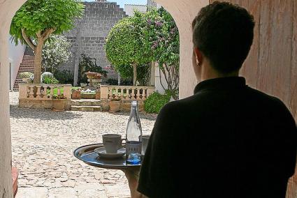 Un camarero sirve en una terraza de Ciutadella