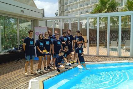 Alumnos participantes ponen a prueba en la piscina el funcionamiento de su barco solar.