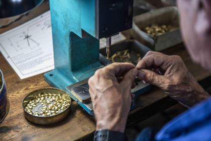 Las manos de un trabajador de una empresa bisutera en Menorca.