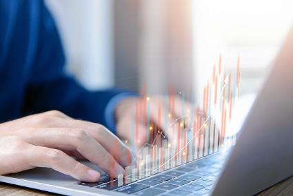 businessman trading stocks on laptop