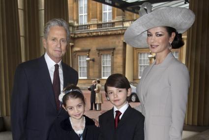 Welsh actress Zeta-Jones poses with her husband and children as they arrive at Buckingham Palace in London