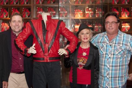 President & CEO of Juliens Auctions Beverly Hills Julien, actress Hedren and Verret of Austin, Texas, buyer of jacket, pose with