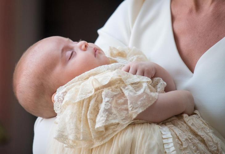 Britain's Catherine, the Duchess of Cambridge, carries Prince Louis as they arrive for his christening service at the Chapel Roy