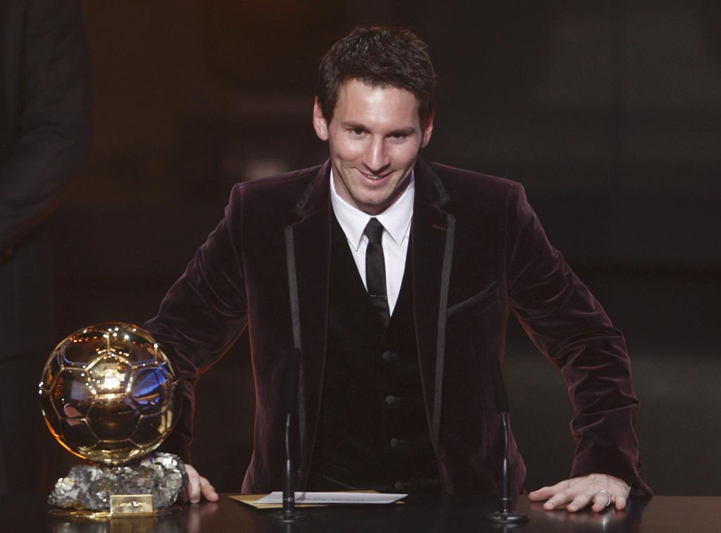 Messi of Argentina, FIFA World Player of the Year poses next to his FIFA Ballon d'Or 2011 trophy during the FIFA Ballon d'Or 201